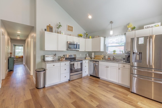 658 Old Chattanooga Pike SW, Cleveland, TN 37311 - kitchen with stainless steel appliances, high vaulted ceiling, a sink, white cabinets, and light wood-style floors
