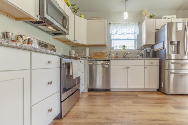 658 Old Chattanooga Pike SW, Cleveland, TN 37311 - kitchen with stainless steel appliances, a sink, white cabinetry, light stone countertops, and light wood-style floors