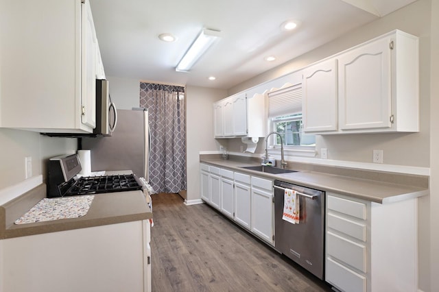 146 Sherron Dr, Dickson, TN 37055 - kitchen featuring appliances with stainless steel finishes, a sink, white cabinets, wood finished floors, and recessed lighting