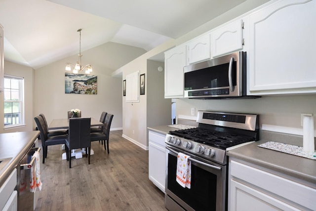146 Sherron Dr, Dickson, TN 37055 - kitchen with stainless steel appliances, wood finished floors, a chandelier, white cabinets, and vaulted ceiling