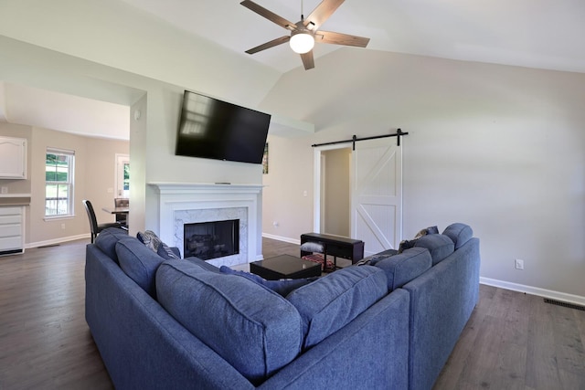 146 Sherron Dr, Dickson, TN 37055 - living area featuring a barn door, a ceiling fan, baseboards, dark wood-style flooring, and lofted ceiling