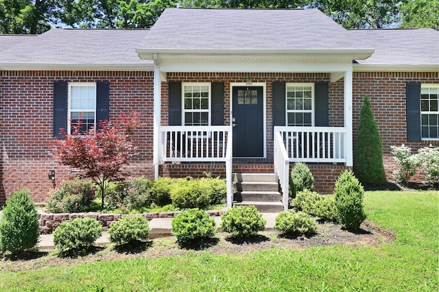 146 Sherron Dr, Dickson, TN 37055 - view of front facade featuring brick siding, covered porch, and a shingled roof