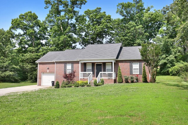 146 Sherron Dr, Dickson, TN 37055 - view of front of home featuring covered porch, brick siding, a front lawn, and concrete driveway