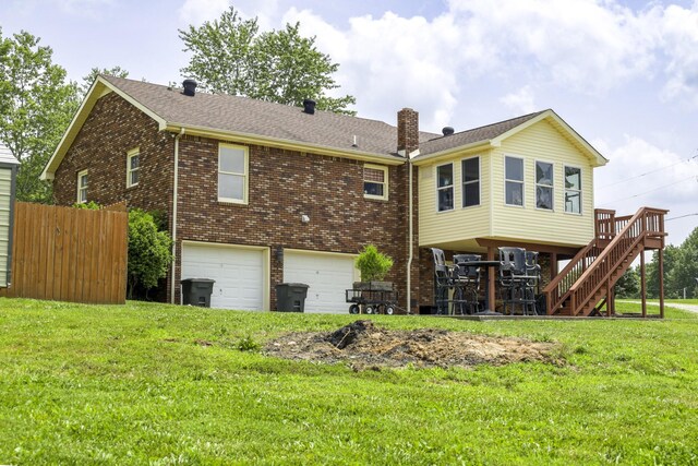 535 Dawson Rd, Cumberland Furnace, TN 37051 - back of property featuring an attached garage, brick siding, stairway, a chimney, and a shingled roof