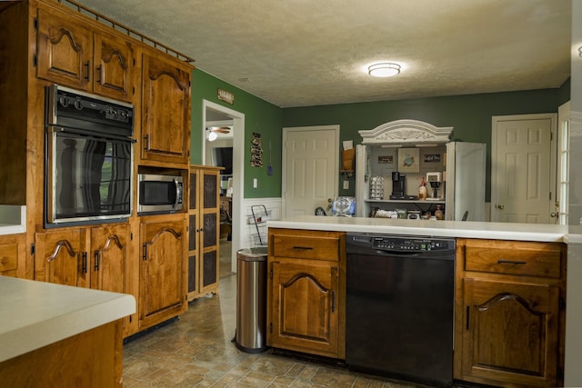 535 Dawson Rd, Cumberland Furnace, TN 37051 - kitchen with black appliances, a textured ceiling, light countertops, ceiling fan, and brown cabinetry