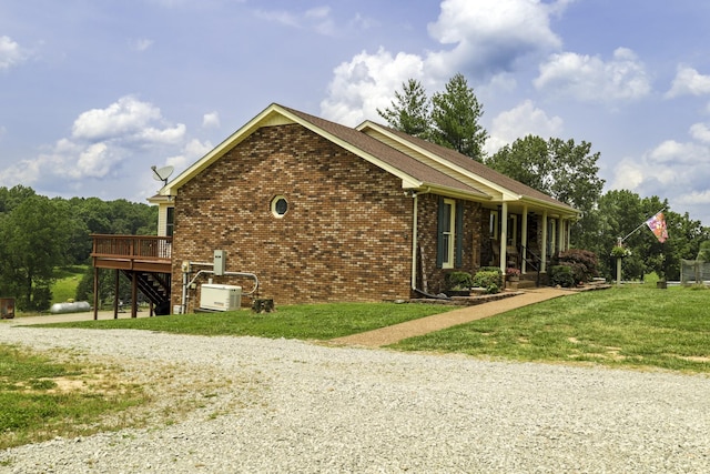535 Dawson Rd, Cumberland Furnace, TN 37051 - view of property exterior featuring brick siding, stairway, a lawn, driveway, and a wooden deck