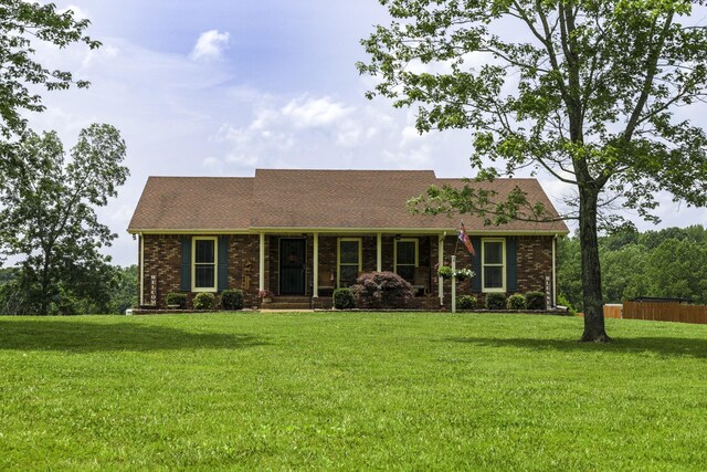 535 Dawson Rd, Cumberland Furnace, TN 37051 - view of front of home featuring a front lawn, roof with shingles, and brick siding
