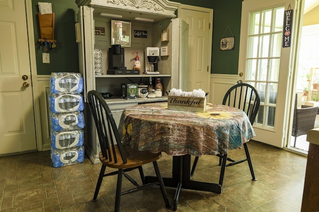 535 Dawson Rd, Cumberland Furnace, TN 37051 - dining area featuring wainscoting, dark stone finish floors, and a decorative wall