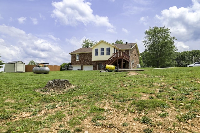535 Dawson Rd, Cumberland Furnace, TN 37051 - back of property featuring brick siding, a shed, stairs, an attached garage, and a wooden deck