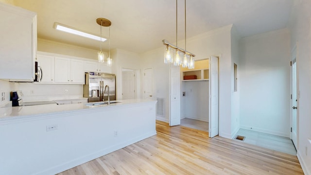 2271 Dewey Dr Unit G2, Spring Hill, TN 37174 - kitchen featuring stainless steel appliances, a sink, crown molding, a peninsula, and light countertops