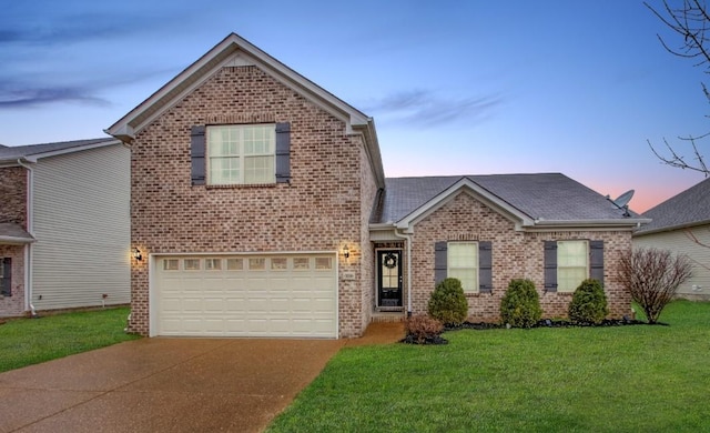 5016 Norman Way, Spring Hill, TN 37174 - traditional-style home with concrete driveway, brick siding, a front lawn, and an attached garage