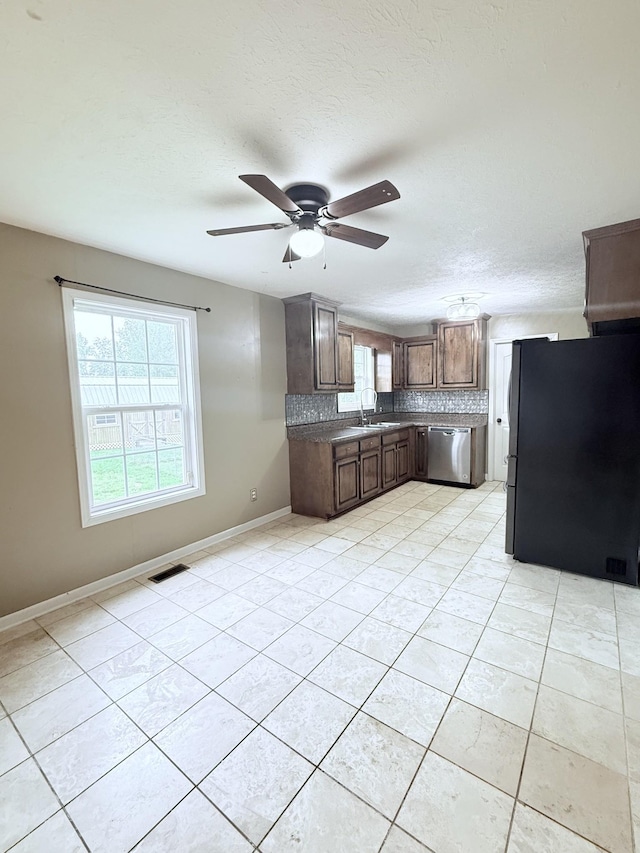 309 Caydras Way, Lafayette, TN 37083 - kitchen featuring stainless steel appliances, tasteful backsplash, a sink, a ceiling fan, and light tile patterned floors