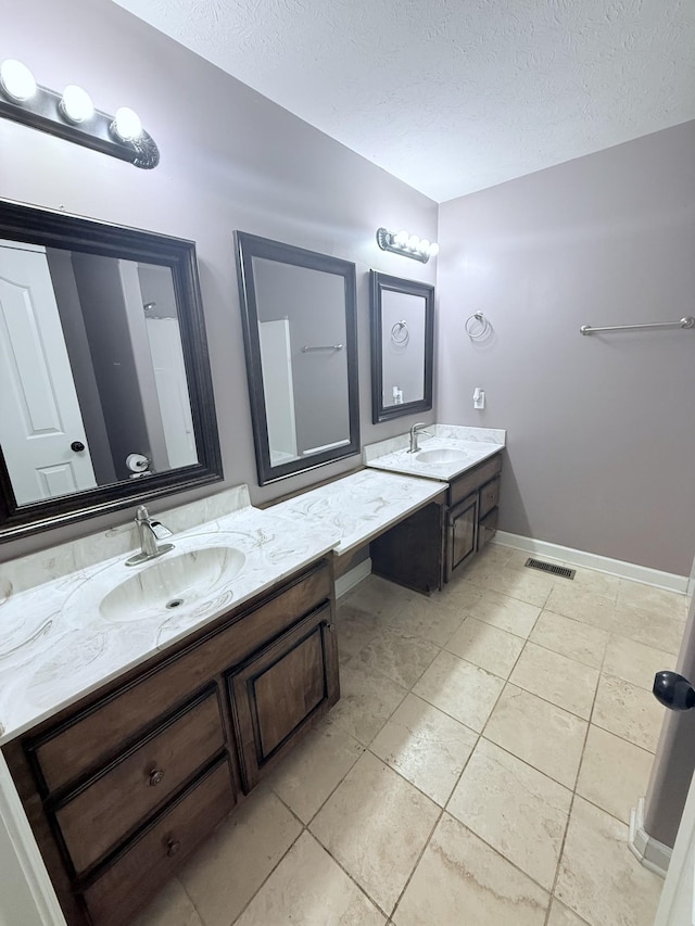 309 Caydras Way, Lafayette, TN 37083 - full bath with double vanity, a textured ceiling, tile patterned flooring, and baseboards
