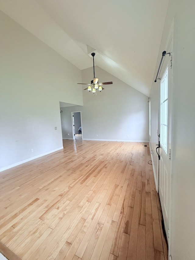 309 Caydras Way, Lafayette, TN 37083 - empty room with high vaulted ceiling, light wood-type flooring, ceiling fan, and baseboards