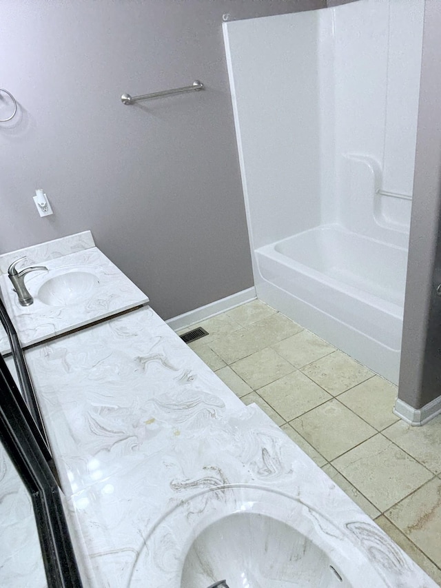 309 Caydras Way, Lafayette, TN 37083 - bathroom with double vanity, baseboards, bathtub / shower combination, and tile patterned floors