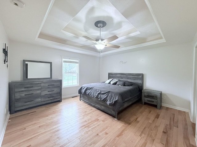 309 Caydras Way, Lafayette, TN 37083 - bedroom with a tray ceiling, light wood-style flooring, and baseboards