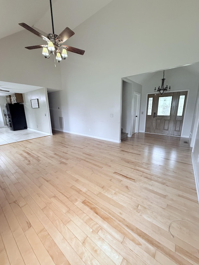 309 Caydras Way, Lafayette, TN 37083 - unfurnished living room featuring high vaulted ceiling, a ceiling fan, a chandelier, light wood finished floors, and baseboards