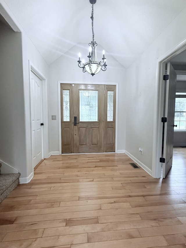 309 Caydras Way, Lafayette, TN 37083 - entryway with a chandelier, light wood-type flooring, vaulted ceiling, and baseboards