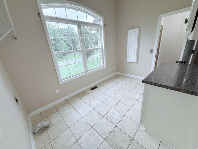 309 Caydras Way, Lafayette, TN 37083 - unfurnished dining area with light tile patterned floors and baseboards