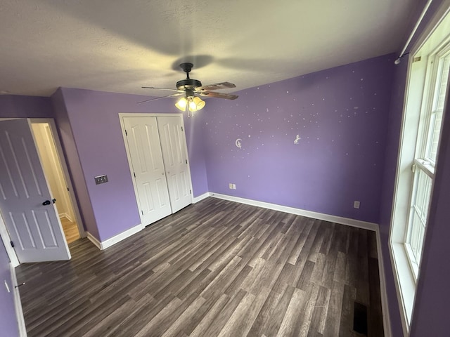 309 Caydras Way, Lafayette, TN 37083 - unfurnished bedroom featuring baseboards, dark wood-type flooring, a closet, and a ceiling fan
