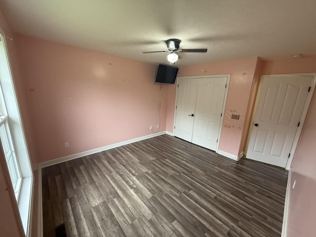 309 Caydras Way, Lafayette, TN 37083 - unfurnished bedroom featuring dark wood-style flooring, a closet, baseboards, ceiling fan, and a textured ceiling