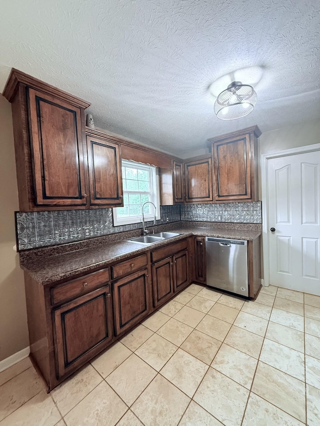 309 Caydras Way, Lafayette, TN 37083 - kitchen with stainless steel dishwasher, a sink, tasteful backsplash, dark countertops, and light tile patterned floors