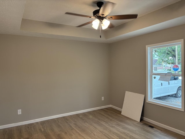 615 6th Ave N, Lewisburg, TN 37091 - unfurnished room with baseboards, a tray ceiling, and light wood-style floors
