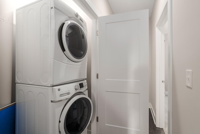 507 Vernon Cir, Nashville, TN 37209 - washroom with stacked washing machine and dryer, wood finished floors, and baseboards