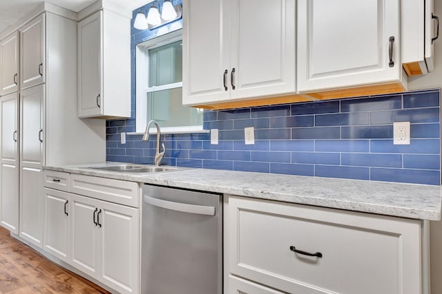 2312 Forrest Fields Dr, Chapel Hill, TN 37034 - kitchen with stainless steel dishwasher, a sink, backsplash, white cabinetry, and light wood-type flooring