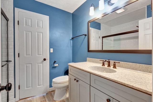 2312 Forrest Fields Dr, Chapel Hill, TN 37034 - full bath featuring vanity, toilet, tiled shower, and wood finished floors