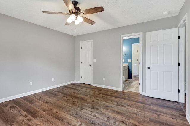 2312 Forrest Fields Dr, Chapel Hill, TN 37034 - unfurnished bedroom featuring baseboards, dark wood finished floors, ensuite bath, a ceiling fan, and a textured ceiling