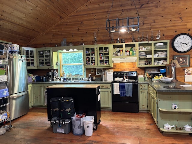 4251 Francisco Rd, Huntland, TN 37345 - kitchen with green cabinetry, black electric range oven, open shelves, freestanding refrigerator, and under cabinet range hood