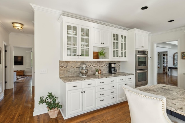 6321 Wescates, Brentwood, TN 37027 - kitchen with double oven, backsplash, light stone countertops, ornamental molding, and glass insert cabinets