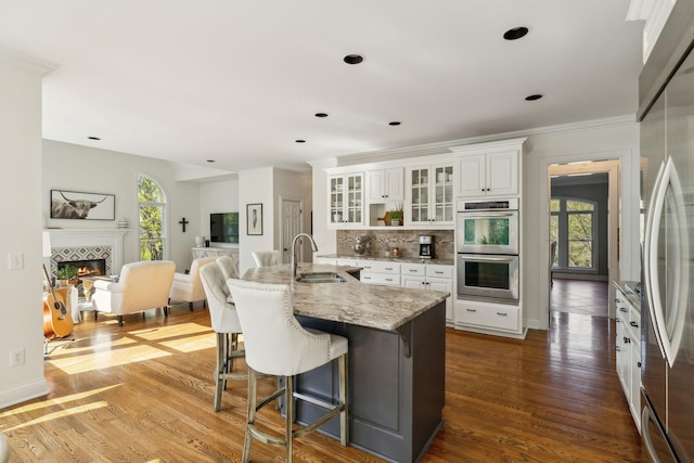 6321 Wescates, Brentwood, TN 37027 - kitchen featuring a sink, stainless steel appliances, light stone countertops, wood finished floors, and tasteful backsplash