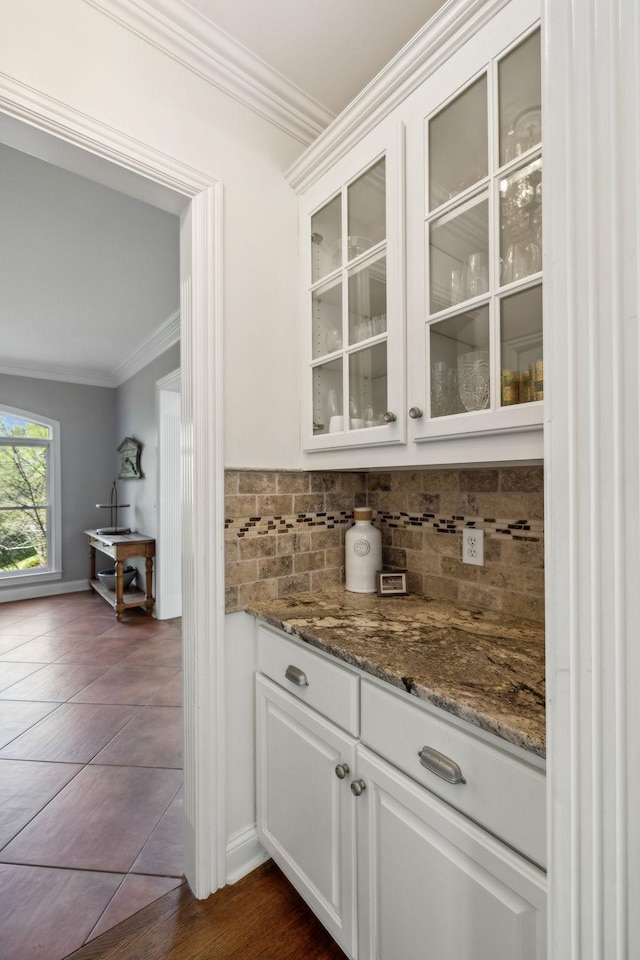 6321 Wescates, Brentwood, TN 37027 - bar area with crown molding, tasteful backsplash, dark tile patterned flooring, and baseboards