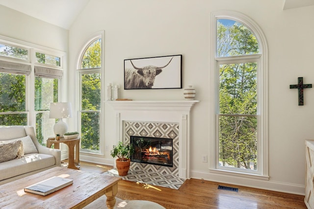 6321 Wescates, Brentwood, TN 37027 - living room featuring wood finished floors, baseboards, a tiled fireplace, and high vaulted ceiling