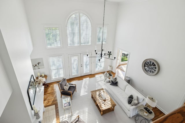6321 Wescates, Brentwood, TN 37027 - living area with a towering ceiling, a chandelier, wood finished floors, and baseboards