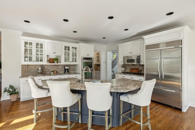 6321 Wescates, Brentwood, TN 37027 - kitchen featuring stainless steel appliances, decorative backsplash, glass insert cabinets, a sink, and white cabinets