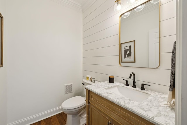 6321 Wescates, Brentwood, TN 37027 - bathroom featuring crown molding, vanity, toilet, wood finished floors, and wooden walls