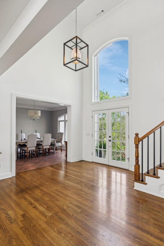 6321 Wescates, Brentwood, TN 37027 - living room featuring a chandelier, a towering ceiling, stairway, ornamental molding, and wood finished floors