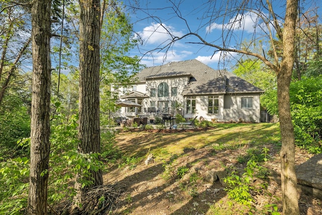 6321 Wescates, Brentwood, TN 37027 - rear view of property featuring a shingled roof and a lawn