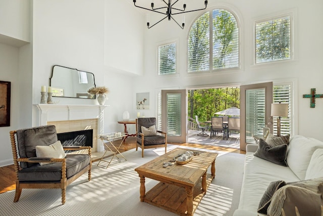 6321 Wescates, Brentwood, TN 37027 - living area with a towering ceiling, plenty of natural light, a chandelier, a tiled fireplace, and wood finished floors