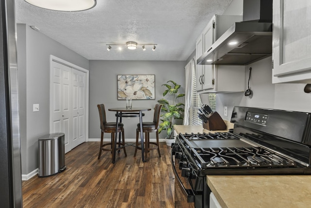 5156 W Oak Highland Dr, Antioch, TN 37013 - kitchen featuring black range with gas cooktop, wall chimney exhaust hood, dark wood finished floors, light countertops, and a textured ceiling