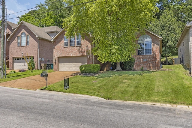 5156 W Oak Highland Dr, Antioch, TN 37013 - view of front of home with a garage, driveway, brick siding, and a front lawn