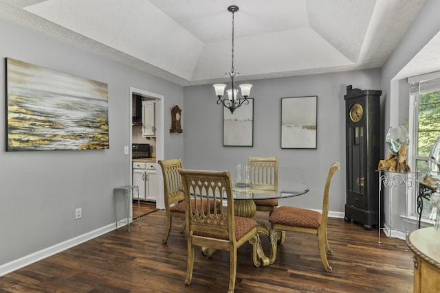 5156 W Oak Highland Dr, Antioch, TN 37013 - dining room with a tray ceiling, dark wood-style flooring, a chandelier, and baseboards