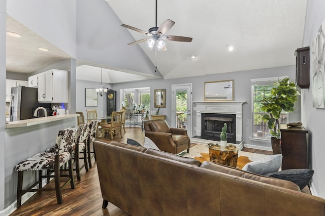 5156 W Oak Highland Dr, Antioch, TN 37013 - living area with dark wood finished floors, a fireplace with raised hearth, a ceiling fan, recessed lighting, and a chandelier