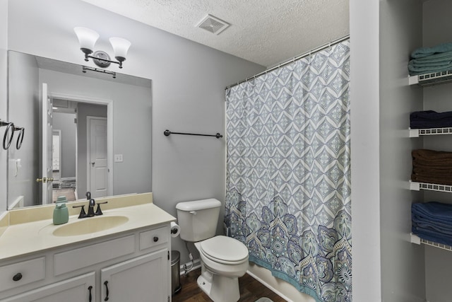 5156 W Oak Highland Dr, Antioch, TN 37013 - bathroom featuring vanity, toilet, wood finished floors, a textured ceiling, and curtained shower