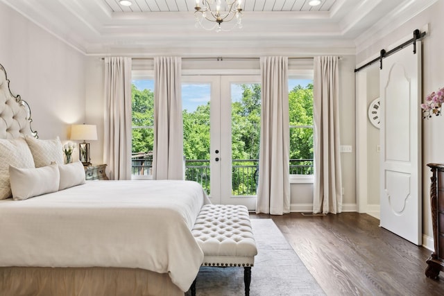 1234 Saddle Springs Dr, Thompsons Station, TN 37179 - bedroom featuring a tray ceiling, a barn door, access to outside, dark wood-style flooring, and crown molding