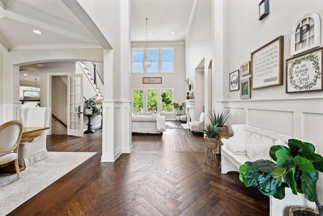 1234 Saddle Springs Dr, Thompsons Station, TN 37179 - entrance foyer with a decorative wall, crown molding, arched walkways, stairway, and a high ceiling