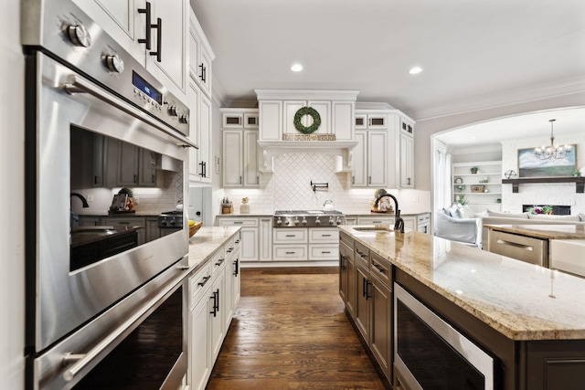 1234 Saddle Springs Dr, Thompsons Station, TN 37179 - kitchen with a sink, stainless steel appliances, glass insert cabinets, recessed lighting, and white cabinets